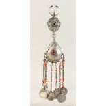 A GOOD ISLAMIC SILVER PENDANT, 10ins long, hung with eight silver coins.