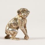 A CAST SILVER MODEL OF A MONKEY. 3cms high. Stamped .925.