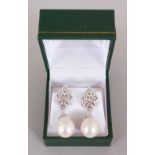 A PAIR OF SILVER AND BAROQUE PEARL EARRINGS in a box.