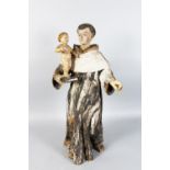 A 17TH-18TH CENTURY ITALIAN CARVED WOOD AND PAINTED STANDING FIGURE OF A MONK holding a child on a