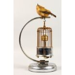 A BIRD CAGE ON STAND with clock.