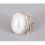 A SILVER AND PEARL RING.