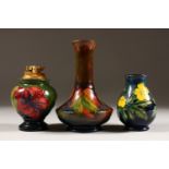 A MOORCROFT POTTERY LIGHTER AND TWO VASES. 4.5ins, 4ins and 6ins high *(3).