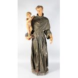 A LARGE 18TH CENTURY CARVED WOOD AND PAINTED STANDING FIGURE holding a child. 50ins high.