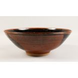 A LARGE BROWN GLAZE POTTERY BOWL with dark interior. 14.5ins diameter.