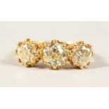 AN 18CT YELLOW GOLD THREE STONE DIAMOND RING of 3.1cts.
