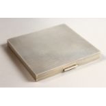 AN ENGINE TURNED SILVER CIGARETTE CASE. 8cms x 9cms. Birmingham 1944.