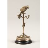 A SILVER COCKATOO STAND. 7cms high. Birmingham 1909.