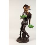 A TWO-COLOUR BRONZE PIXIE holding two leaves. 2ft 8ins high.