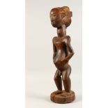 A LARGE TRIBAL CARVED WOOD FIGURE. 26ins high.