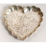 A CONTINENTAL SILVER HEART SHAPED DISH, repousse with a shepherd and sheep. 11cms wide.