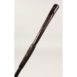 AN AFRICAN HARDWOOD WALKING STICK/THROWING CLUB, with geometric carved decoration. 36ins long.