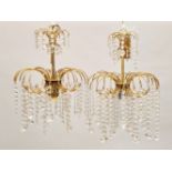 A PAIR OF 20TH CENTURY BRASS AND CUT GLASS CHANDELIERS, with two tiers of prism drops. 16ins high