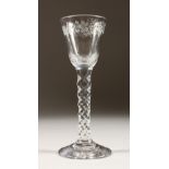 A GEORGIAN WINE GLASS, the bowl engraved with fruit vines, with a facet stem. 6ins high.