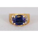 AN 18CT GOLD AND BLUE STONE RING.