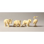TWO SMALL CARVED IVORY ELEPHANTS, STORK AND A DOG (4).