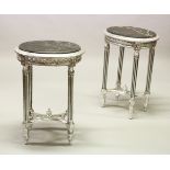 A PAIR OF SILVERED OVAL TABLES, with inset marble tops, on fluted legs. 1ft 7ins wide x 2ft 4ins