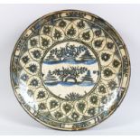 A 17TH-18TH CENTURY PERSIAN SAFAVID BLUE AND WHITE GLAZED CIRCULAR DISH, the centre with flowers and