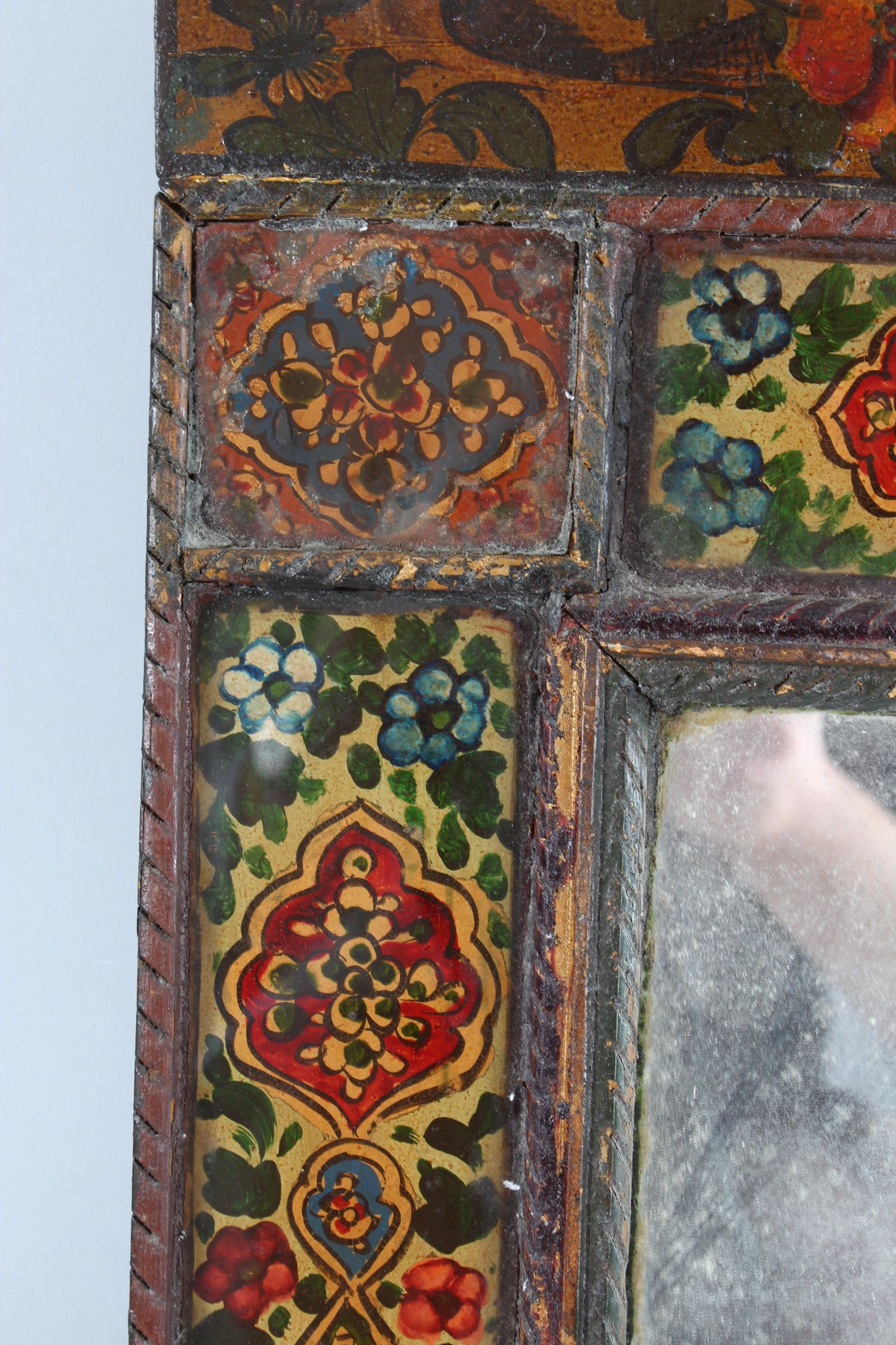 A 19TH CENTURY PERSIAN QAJAR HAND PAINTED WOODEN MIRROR, with shaped top, the mirrored panel - Image 3 of 6