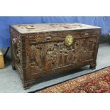 A LARGE EARLY 20TH CENTURY CHINESE CAMPHORWOOD CHEST, decorated overall in deeply carved relief with