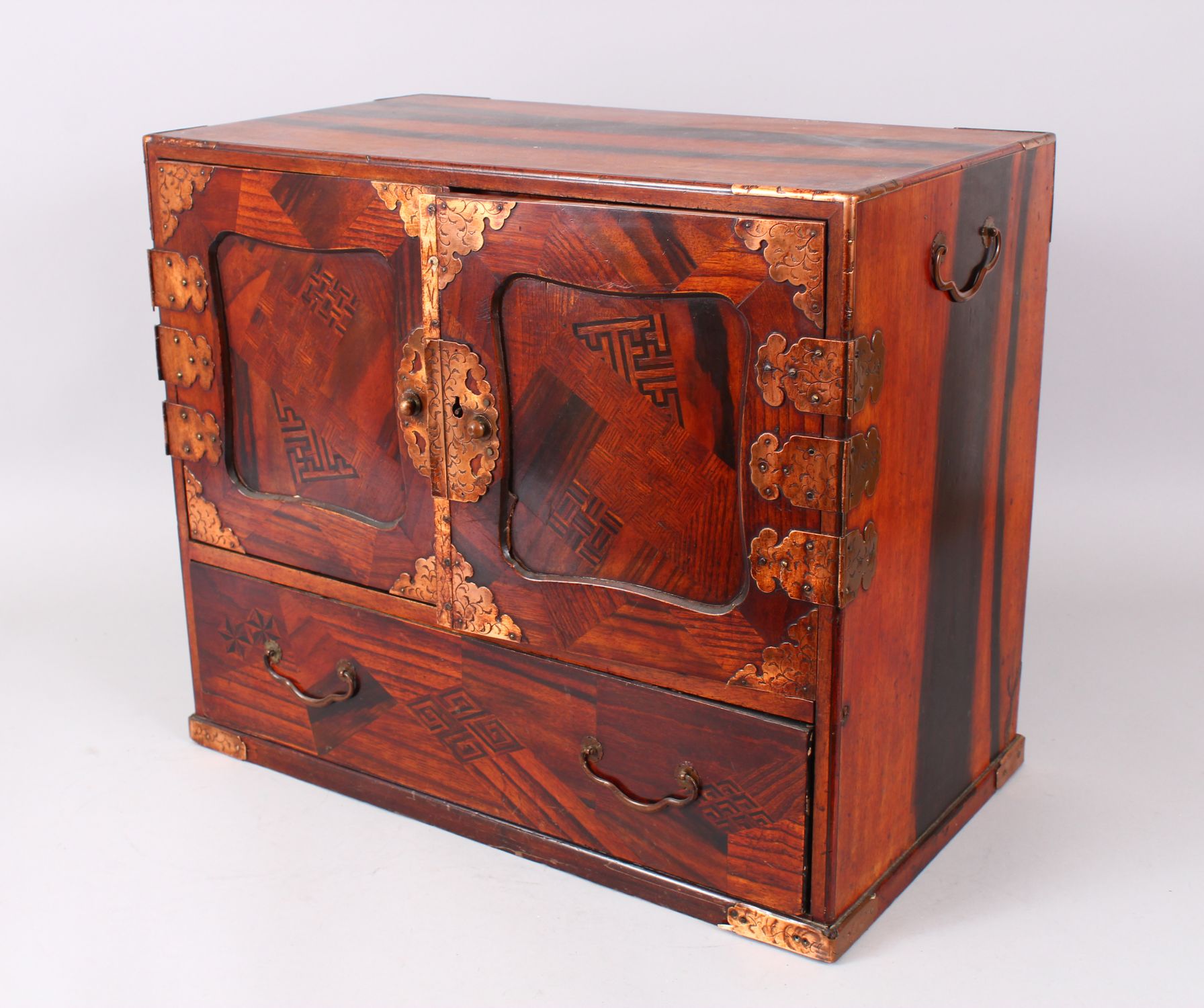 A 19TH CENTURY JAPANESE PARQUETRY CABINET, with double panel doors enclosing 4 drawers over a long