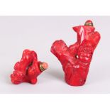 TWO CHINESE RED CORAL SNUFF BOTTLES & STOPPERS, each carved in the form of Budai and a tree trunk,