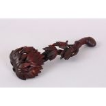A CHINESE CARVED WOOD SCEPTRE. 20cm long.