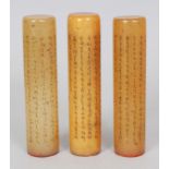 THREE CHINESE SOAPSTONE SEALS, of cylindrical form, each engraved and stained with columns of