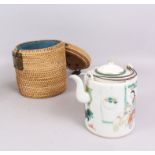 A CHINESE PORCELAIN TEAPOT, circa 1900, with matched cover and with fitted wicker work container,