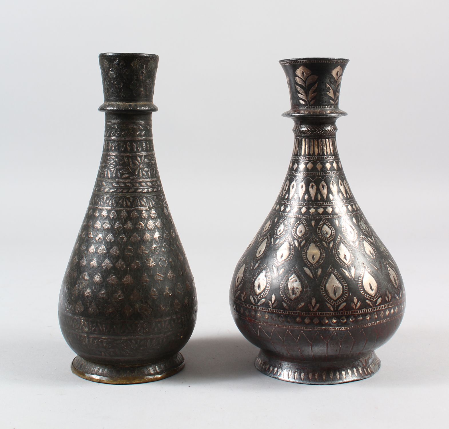 TWO EARLY 19TH CENTURY INDIAN BIDRI SILVER INLAID HUQQA BOTTLES, 20cm high.