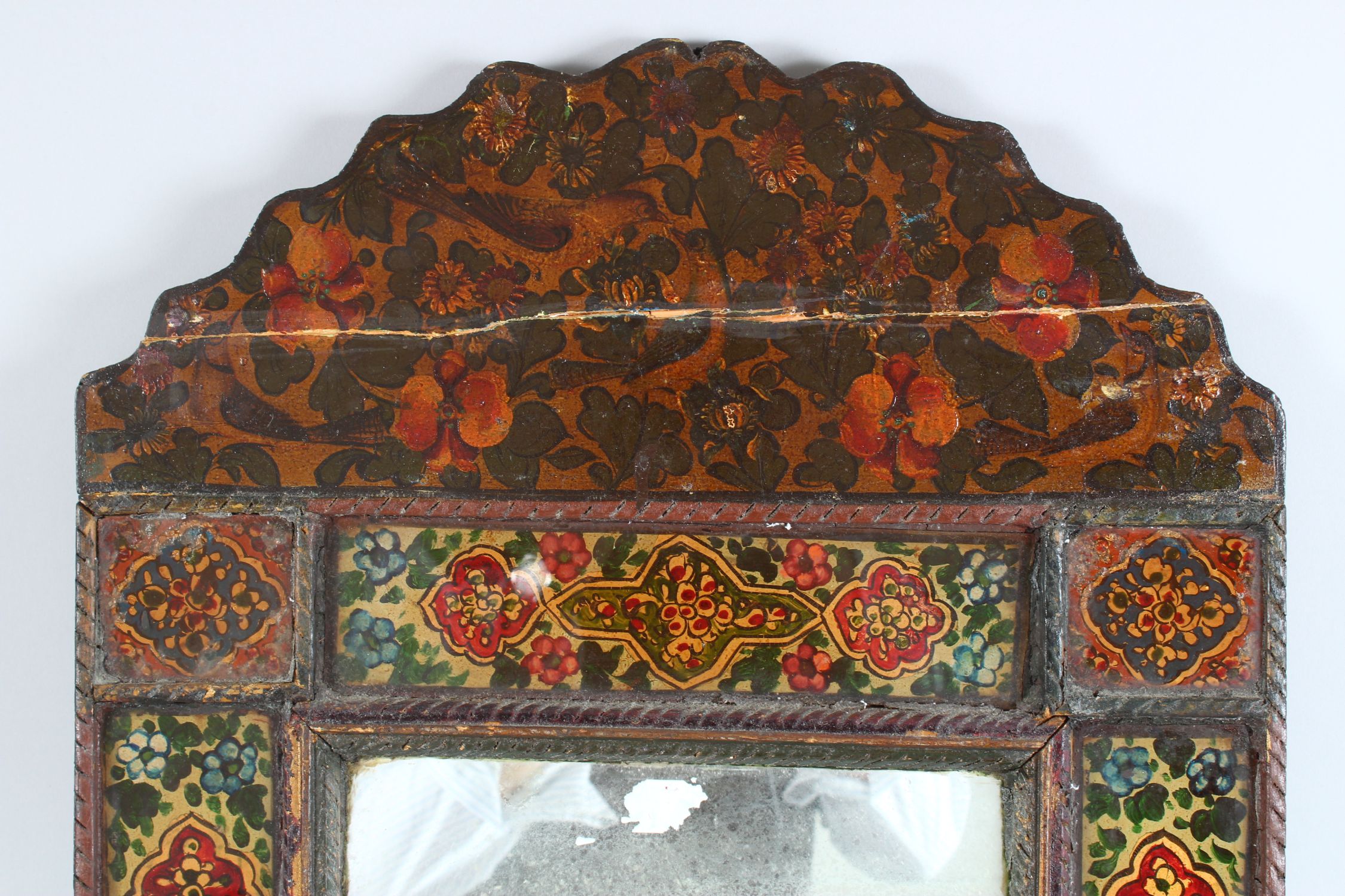 A 19TH CENTURY PERSIAN QAJAR HAND PAINTED WOODEN MIRROR, with shaped top, the mirrored panel - Image 2 of 6