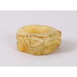 A CHINESE JADE RING, snake and dragon carving. 4cm diameter