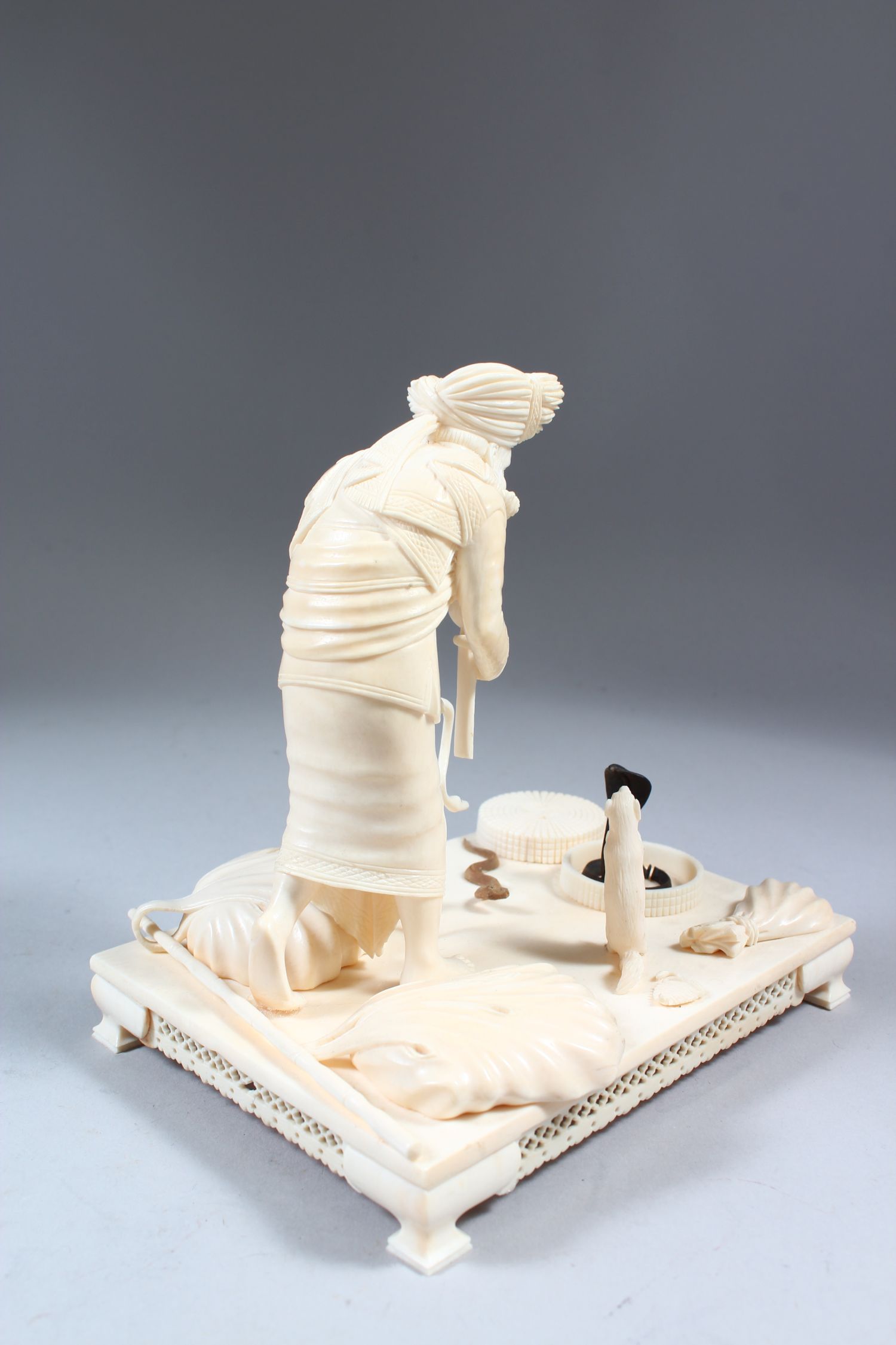 A GOOD 19TH CENTURY INDIAN CARVED IVORY GROUP OF A SNAKE CHARMER with three snakes, standing on a - Image 7 of 7