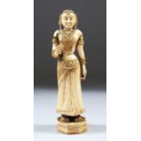 A 17TH-18TH CENTURY INDIAN POLYCHROME CARVED IVORY FIGURE of a young lady standing on an octagonal