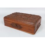 A 20TH CENTURY PERSIAN CARVED WOOD CIGAR BOX AND COVER, the lid carved with figures and calligraphy,