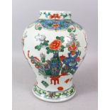 A CHINESE FAMILLE VERTE BULBOUS VASE, painted with panels of furniture, vases, flowers etc. (no