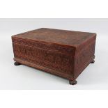 A 19TH CENTURY BOMBAY CARVED SANDLEWOOD BOX AND COVER, with fitted interior supported on four claw