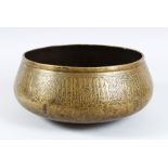 A 14TH CENTURY MAMLUK BRASS BOWL, EGYPT OR SYRIA, the side with an engraved motifs, 26cm diameter.