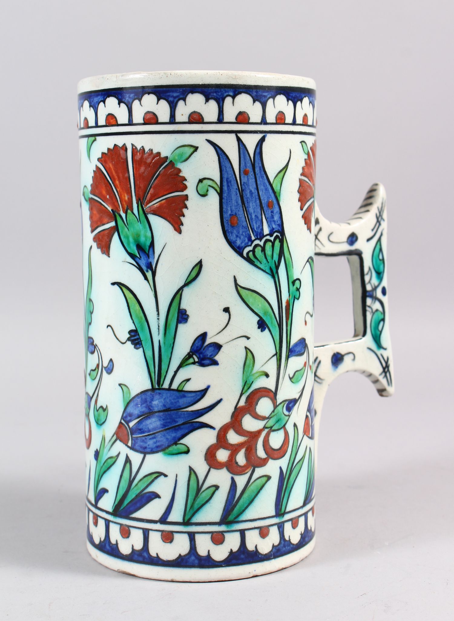 A 19TH CENTURY CANTAGALLI IZNIK STYLE POTTERY TANKARD, the sides with blue ground and flower
