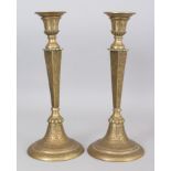 A PAIR OF BRASS CANDLESTICKS, PERSIA, 20TH CENTURY, of European form, on splayed foot, with