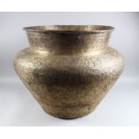 A LARGE 19TH CENTURY ISLAMIC DAMASCUS HAND CHASED BRASS BOWL, 48cm high, 70cm diameter.