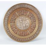 A SOUTH INDIAN TANJORE SILVER AND COPPER INLAID BRASS CIRCULAR PLAQUE, CIRCA 1900, 57cm diameter.