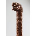 A 19TH CENTURY SOUTH INDIAN MYSORE CARVED SANDLEWOOD WALKING STICK, CIRCA 1900, with carved stem and