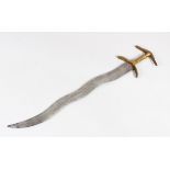 AN 18TH/ 19TH CENTURY SOUTH INDIAN DAGGER with wavy blade, 53cm long.