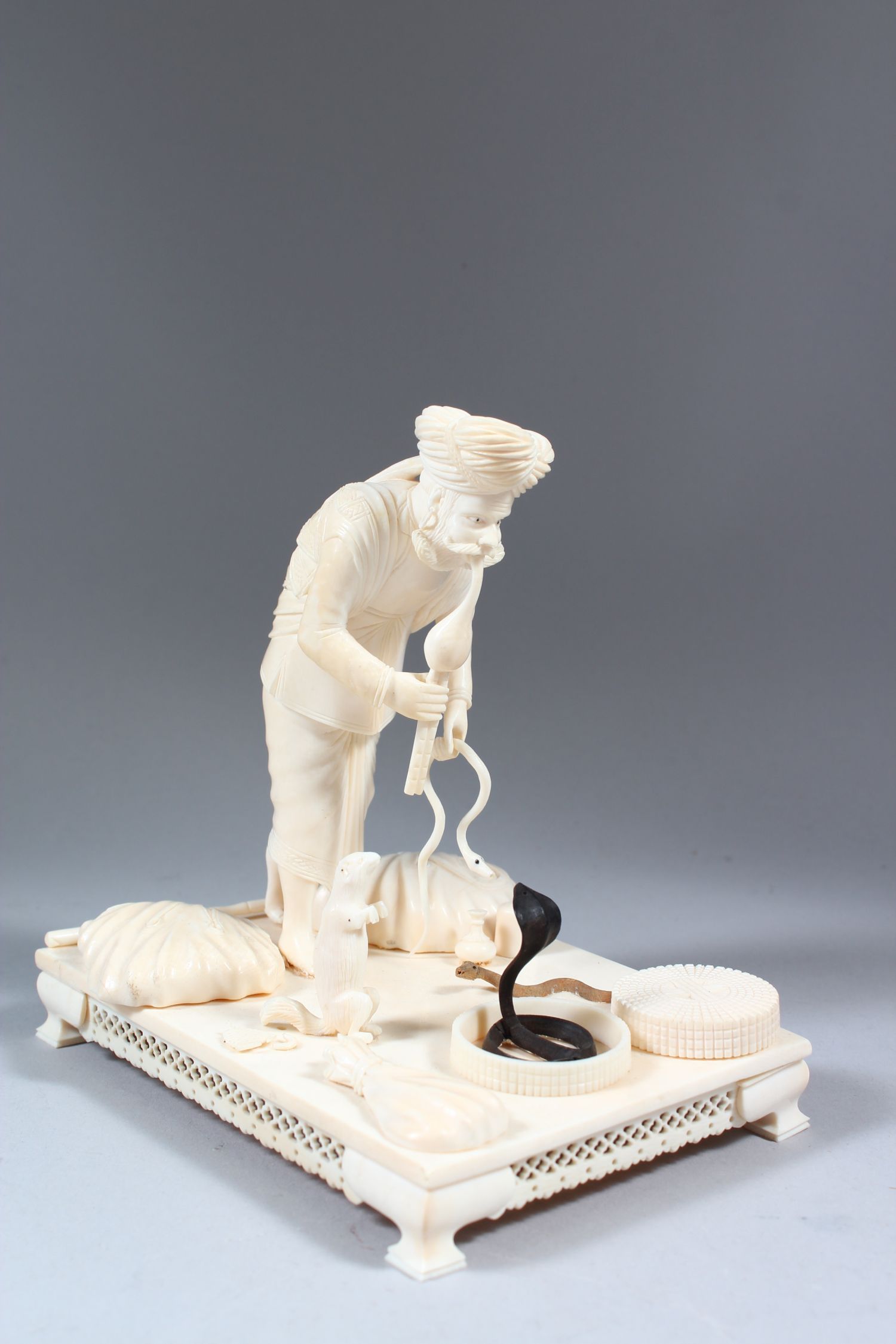 A GOOD 19TH CENTURY INDIAN CARVED IVORY GROUP OF A SNAKE CHARMER with three snakes, standing on a - Image 2 of 7
