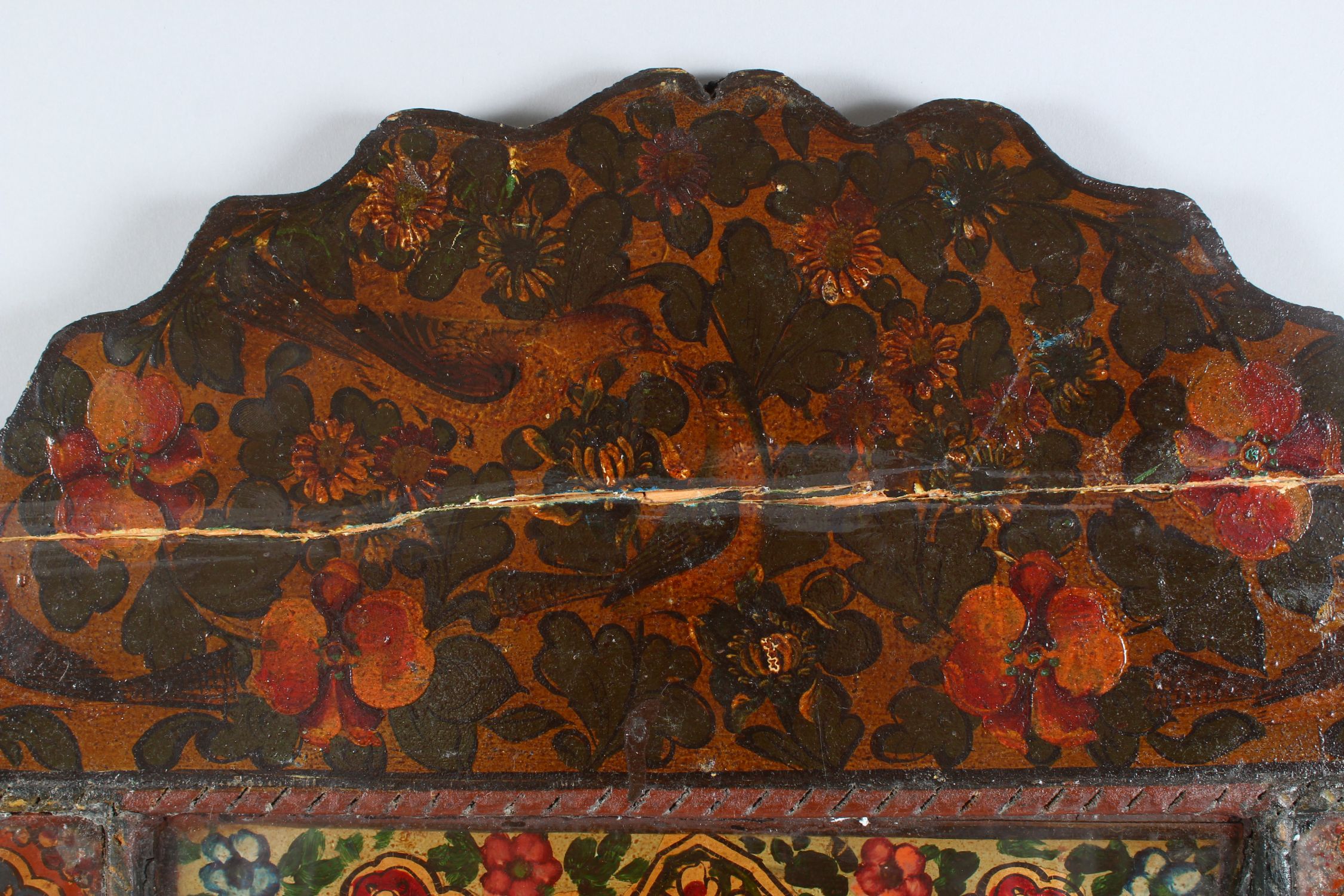 A 19TH CENTURY PERSIAN QAJAR HAND PAINTED WOODEN MIRROR, with shaped top, the mirrored panel - Image 5 of 6