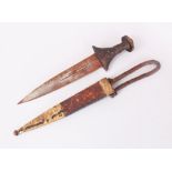 A PERSIAN DAGGER, PROBABLY 19TH CENTURY, with wood hilt and leather scabbard