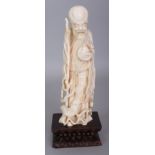 AN EARLY 20TH CENTURY CHINESE CARVED IVORY FIGURE OF SHOU LAO, together with a fixed wood lotus