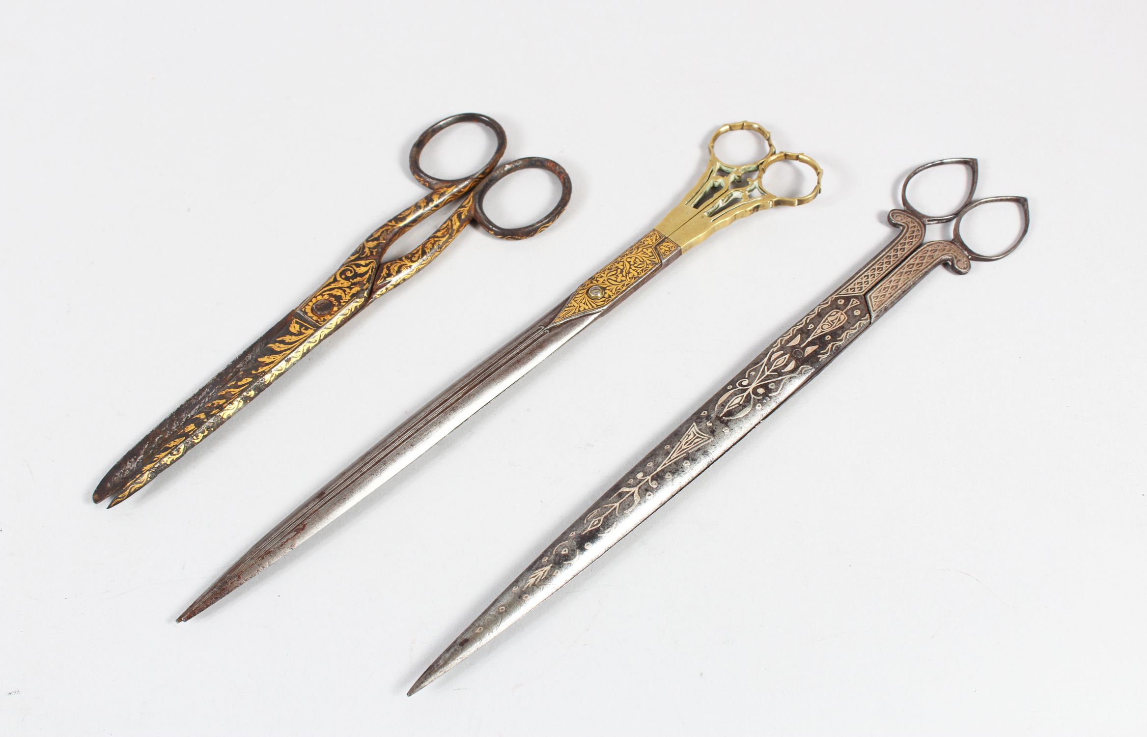 THREE PAIRS OF 19TH CENTURY OTTOMAN SILVER AND GOLD INLAID SCISSORS.