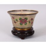 A CHINESE PLIQUE-A-JOUR CIRCULAR BOWL, decorated with a band of roses. 12cm diameter.